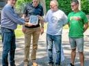 Vilnis Vosekalns, YL2KF (left), presents the Unlimited Cass Award plaque to YL2KL, YL2GM, and YL1ZF during the Latvian Amateur Radio League’s summer gathering.